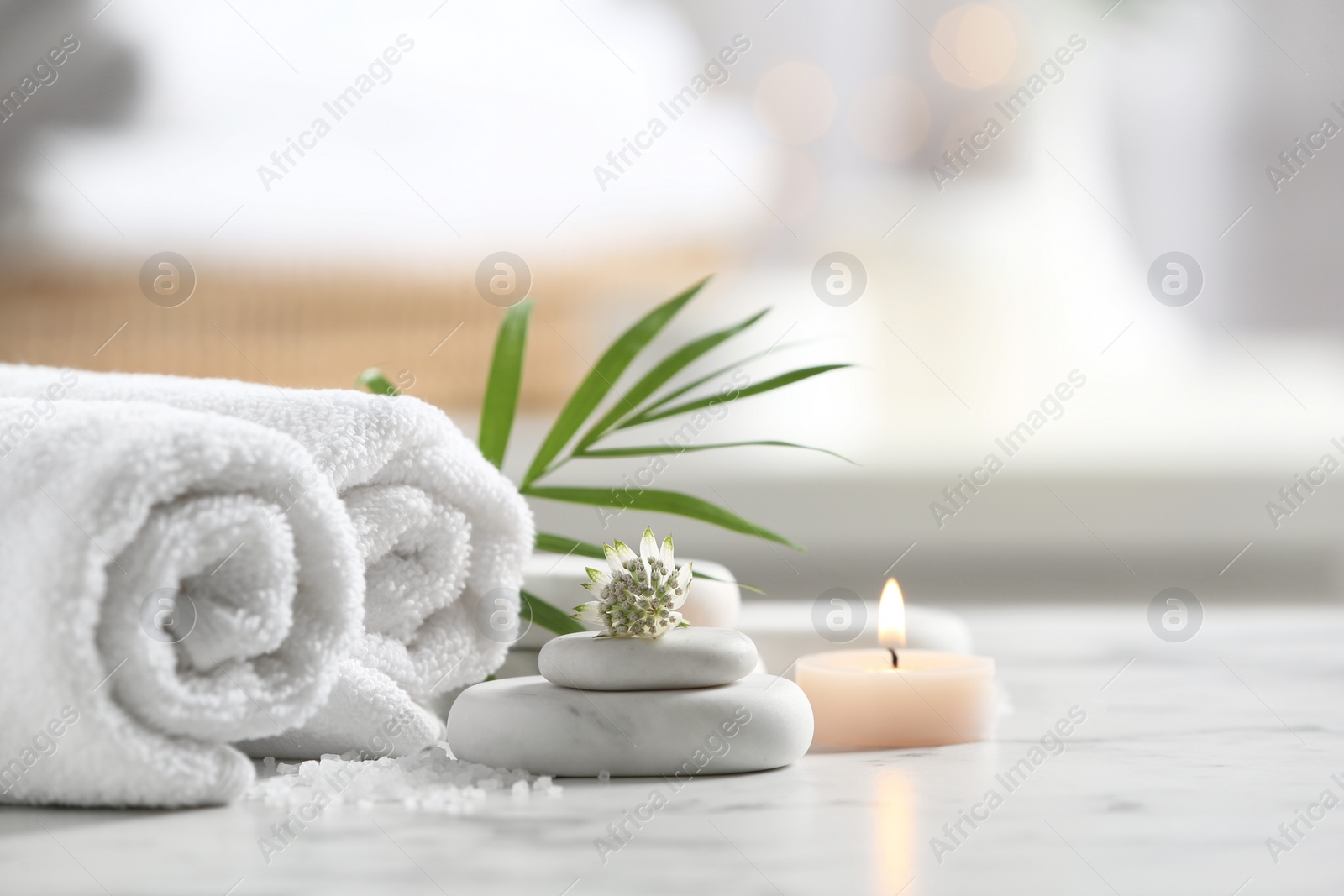 Photo of Beautiful composition with spa stones on white marble table