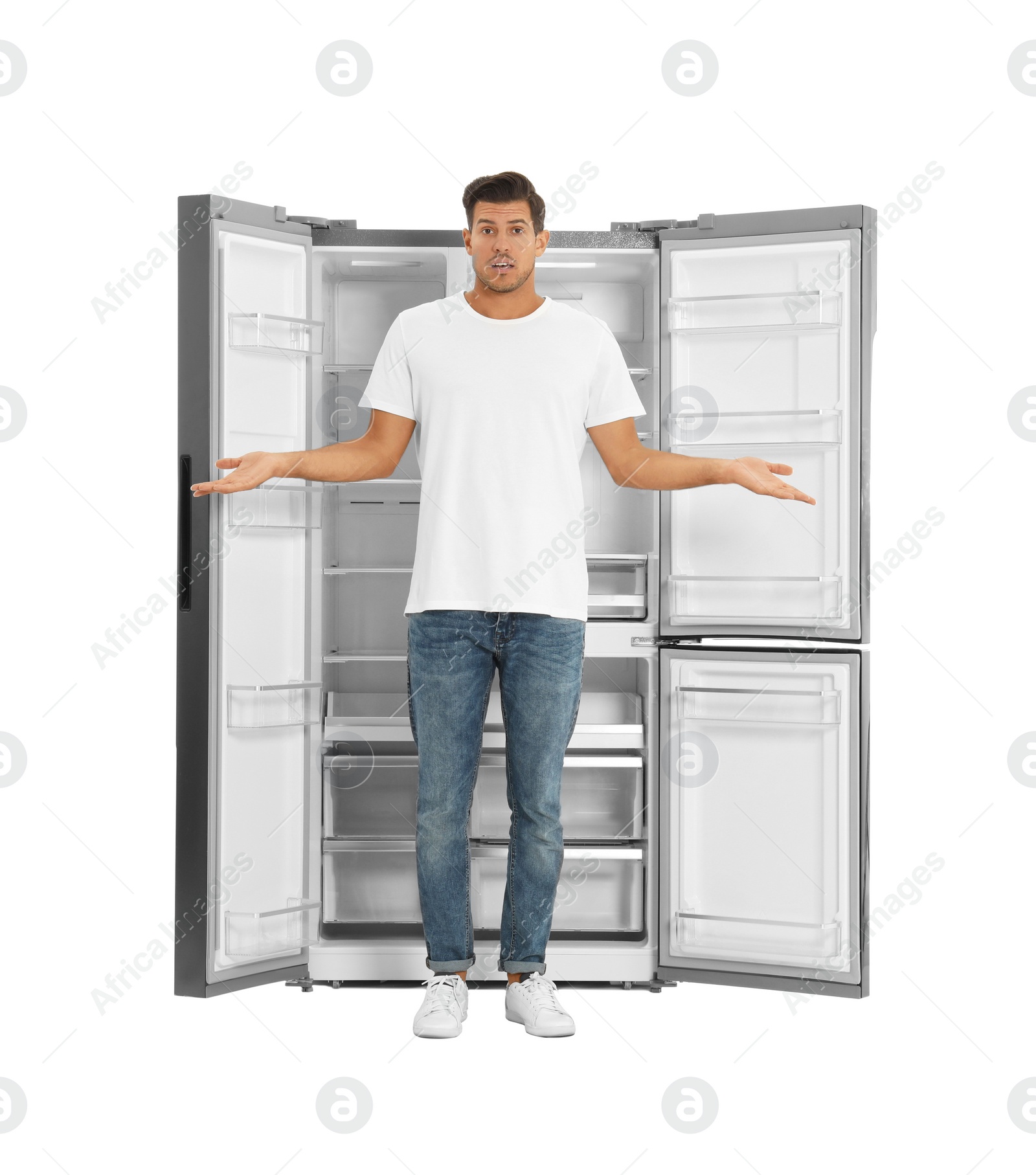 Photo of Man near open empty refrigerator on white background