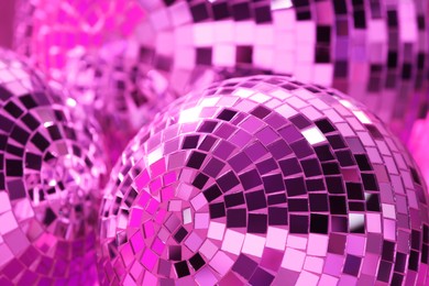 Closeup view of shiny disco balls, toned in pink