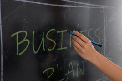 Business trainer with pen using interactive board, closeup