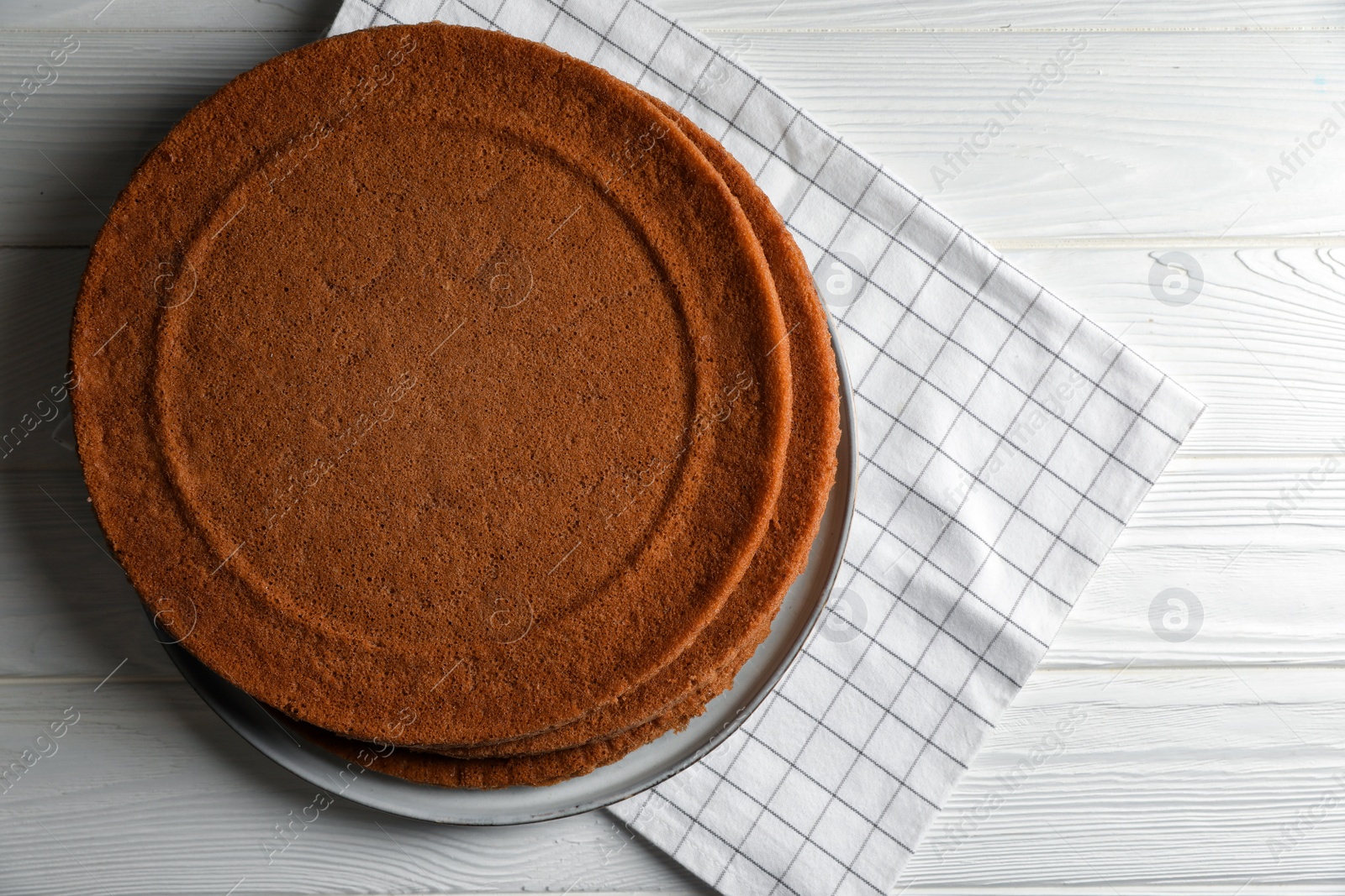 Photo of Delicious homemade sponge cakes on white wooden table, top view