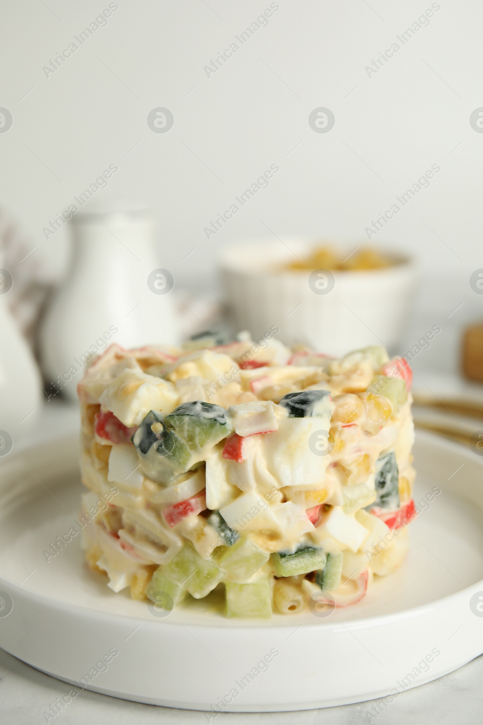 Photo of Delicious salad with fresh crab sticks on plate, closeup