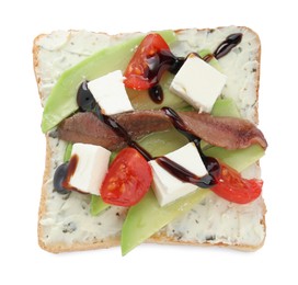 Photo of Delicious sandwich with anchovy, cheese, tomato and sauce on white background, top view