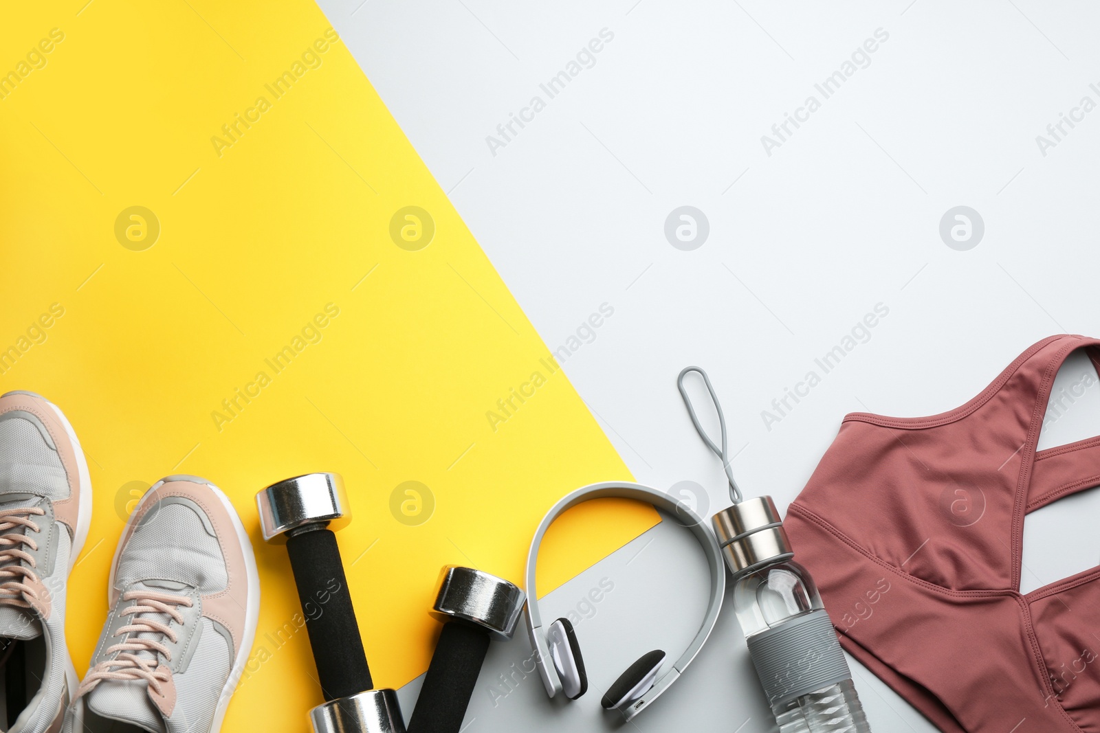 Photo of Flat lay composition with sportswear and equipment on color background, space for text. Gym workout