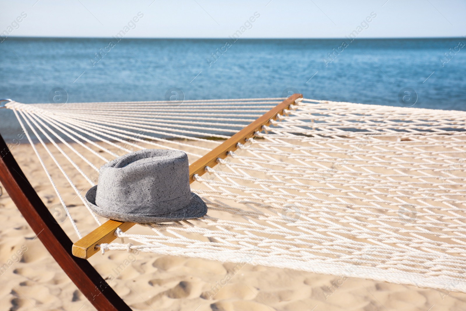 Photo of Hammock and hat at seaside. Time to relax