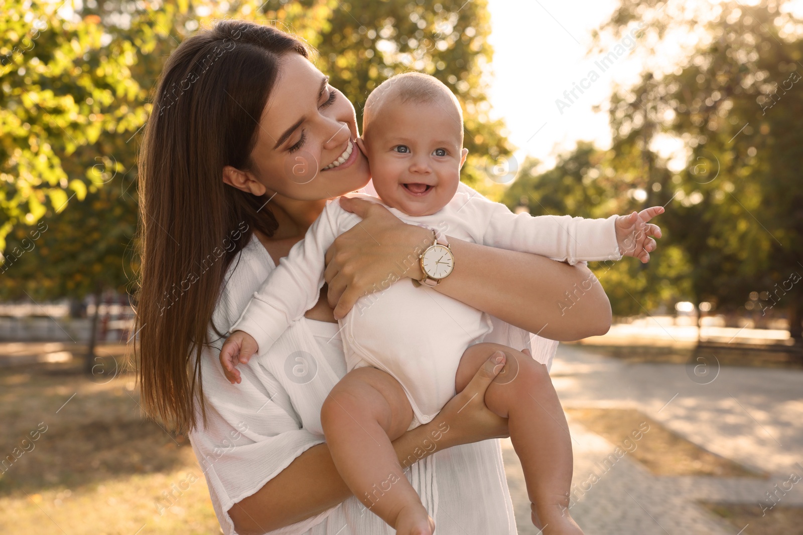 Photo of Young mother with her cute baby in park on sunny day