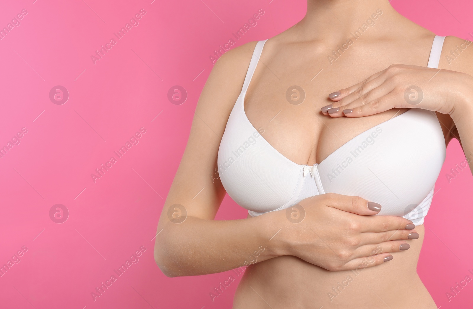 Photo of Woman checking her breast on color background, closeup. Space for text