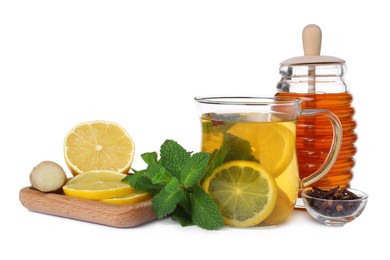 Glass cup of immunity boosting drink and ingredients on white background