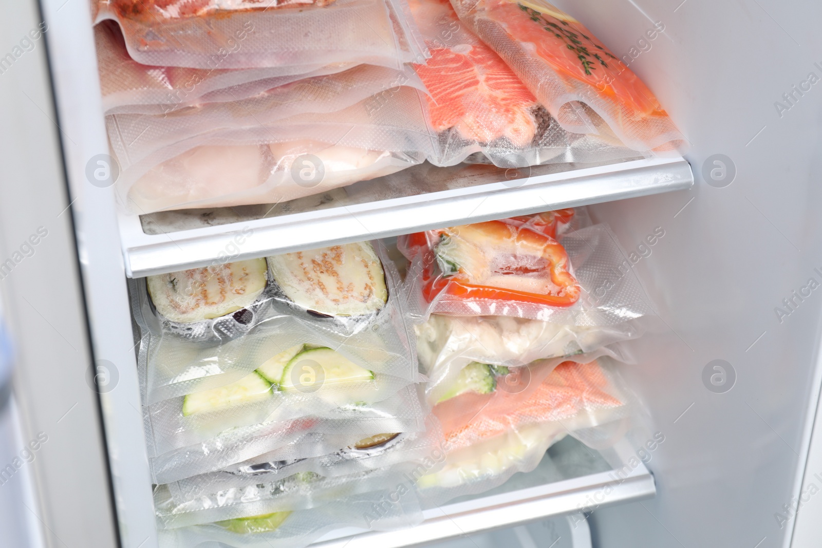 Photo of Vacuum bags with different products in fridge. Food storage