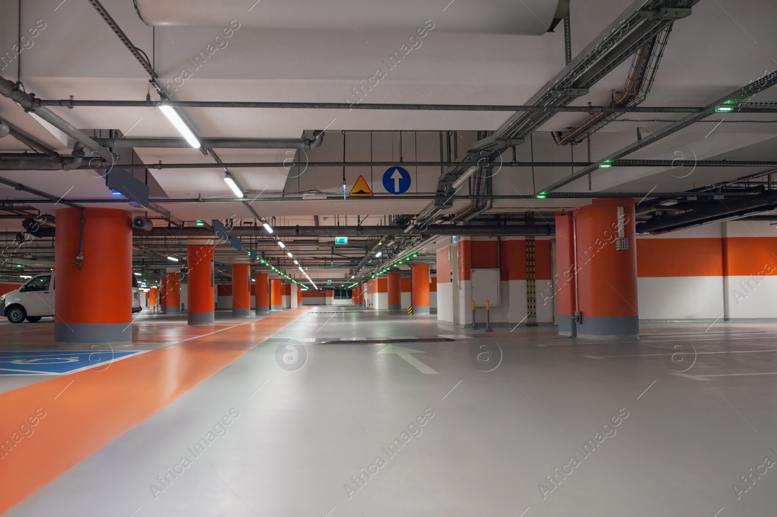 Photo of Empty car parking garage with lighting and columns