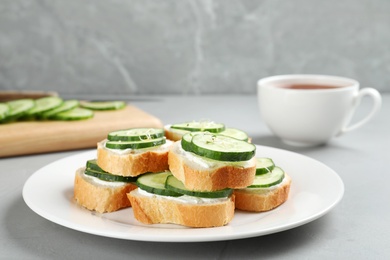 Photo of Plate with traditional English cucumber sandwiches on table. Space for text