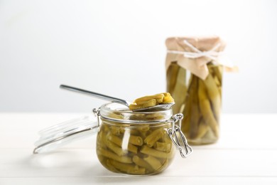 Photo of Canned green beans on white wooden table