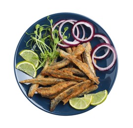 Plate with delicious fried anchovies, lime slices, microgreens and onion rings on white background, top view