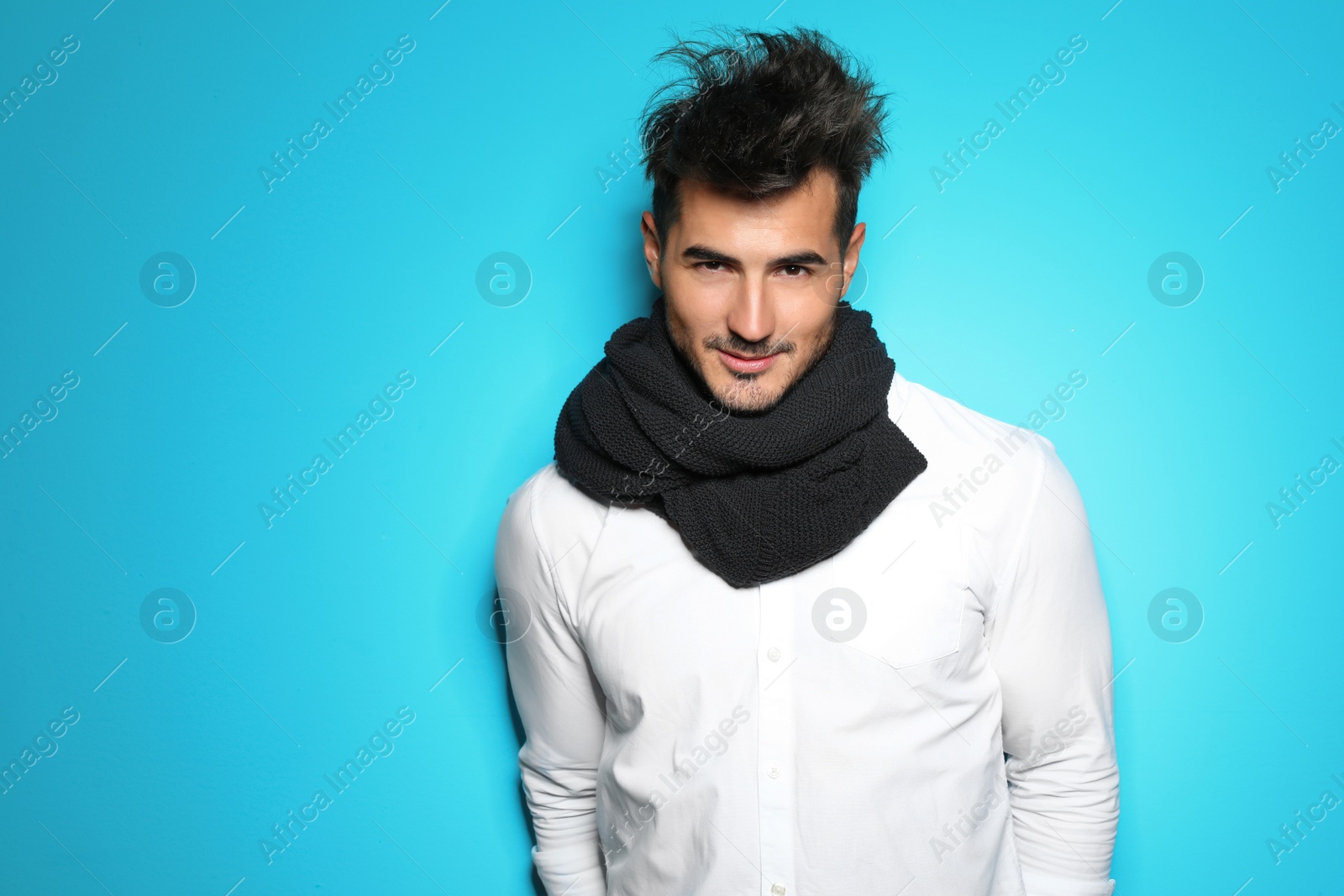 Photo of Young man with trendy hairstyle posing on color background