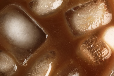 Tasty coffee with ice cubes, top view