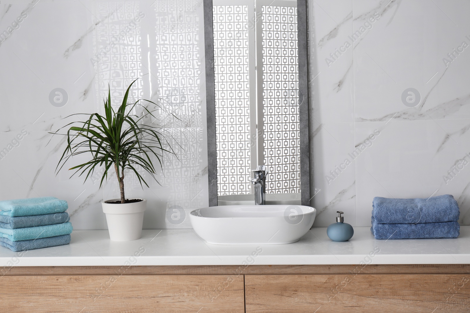 Photo of Modern mirror and vessel sink in stylish bathroom