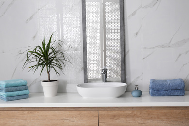 Modern mirror and vessel sink in stylish bathroom