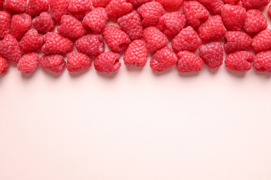 Photo of Fresh sweet ripe raspberries on pink background, flat lay. Space for text