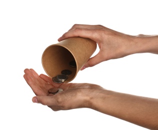 Poor woman holding cup with coins on white background, closeup