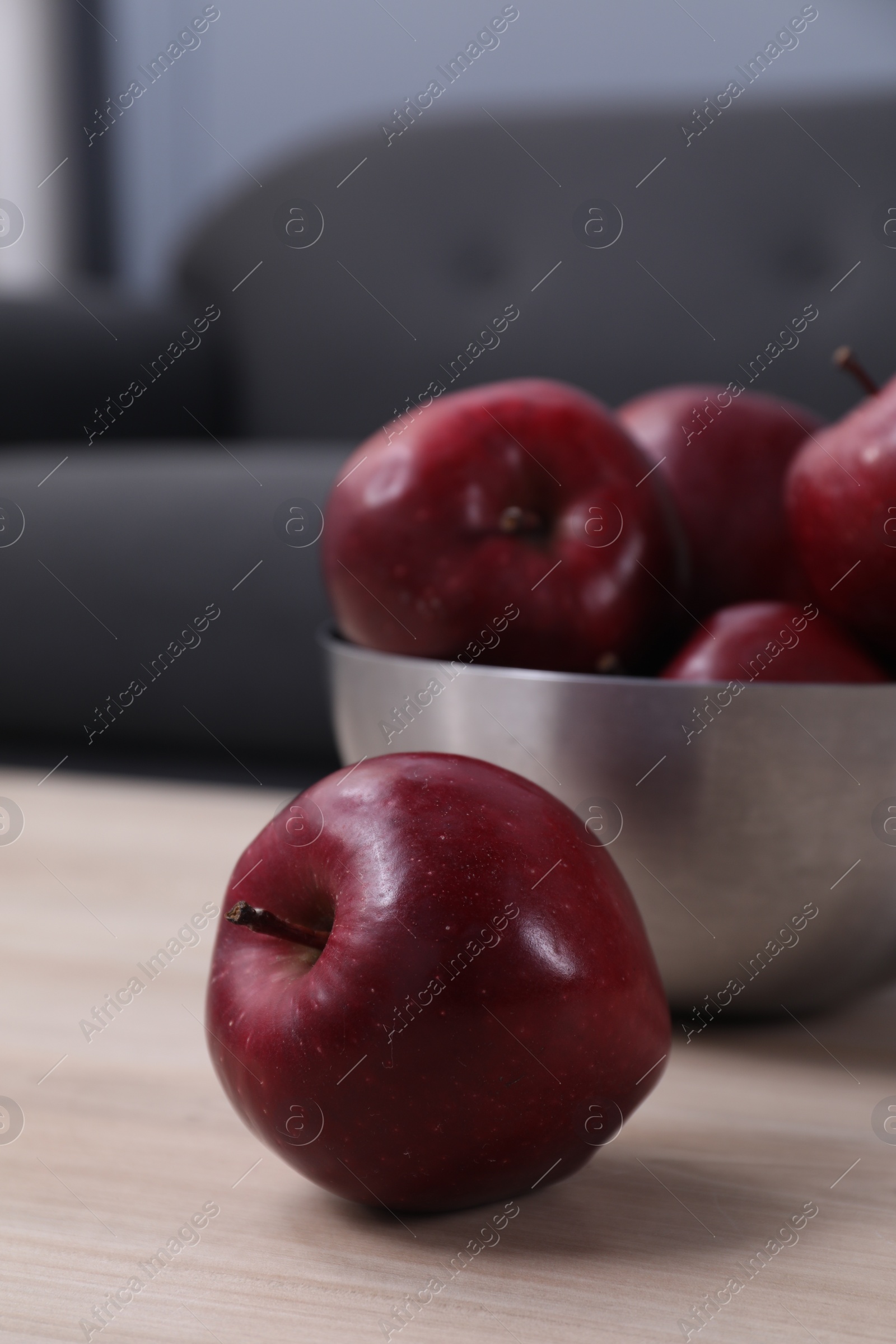 Photo of Red apples on wooden table indoors, closeup