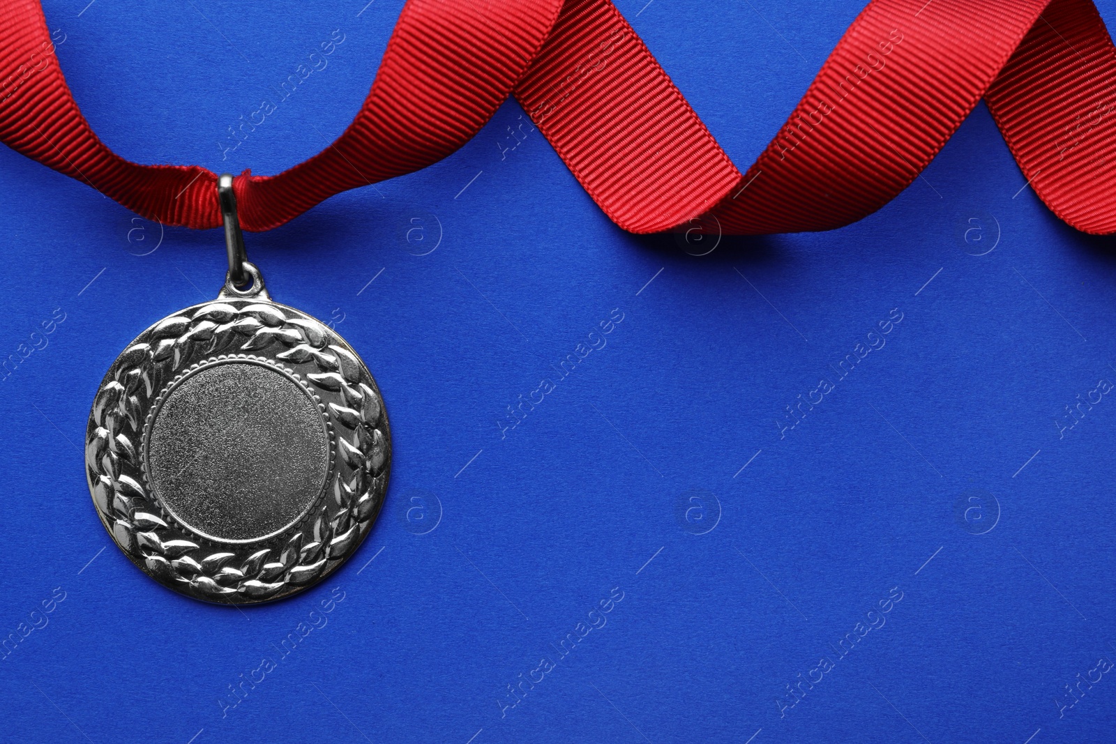 Photo of Gold medal with space for design on color background, top view. Victory concept