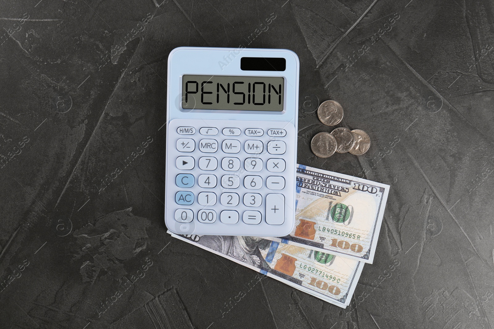 Image of Calculator with word Pension and money on grey table, top view