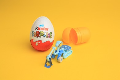 Sveti Vlas, Bulgaria - July 3, 2023: Kinder Surprise Egg, plastic capsule and toy on yellow background