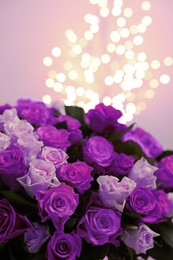 Image of Bouquet of violet roses against blurred background, closeup. Funeral attributes