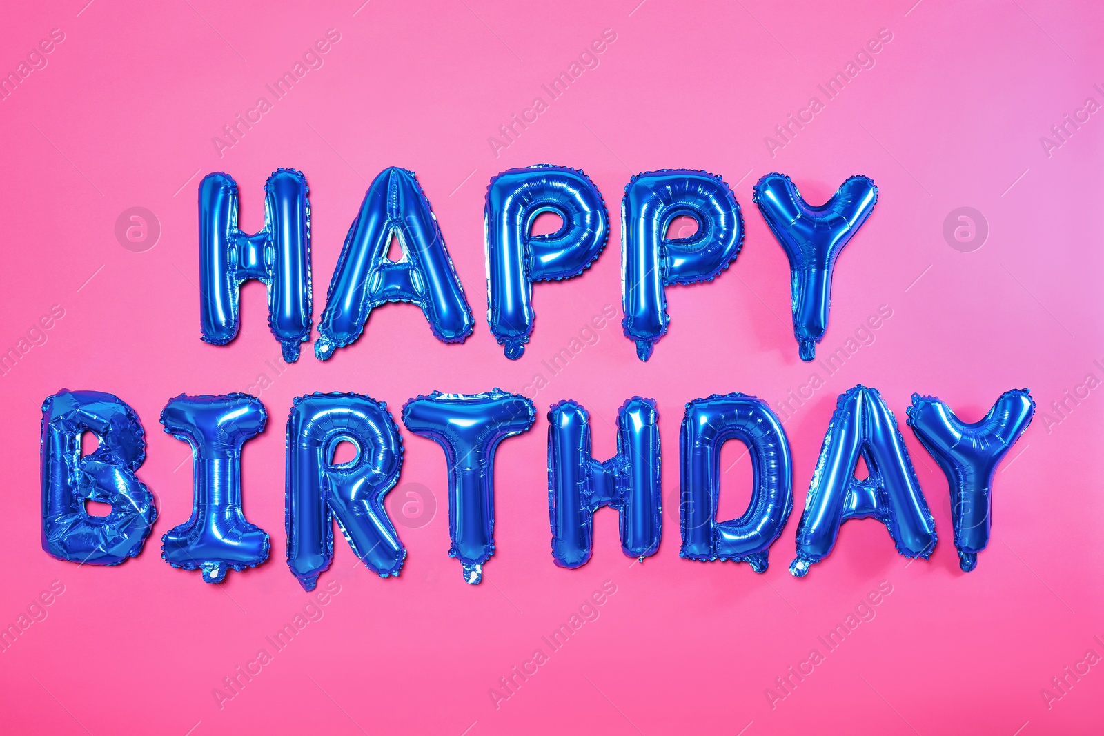 Photo of Phrase HAPPY BIRTHDAY made of blue foil balloon letters on pink background