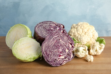 Different sorts of cabbage on wooden table