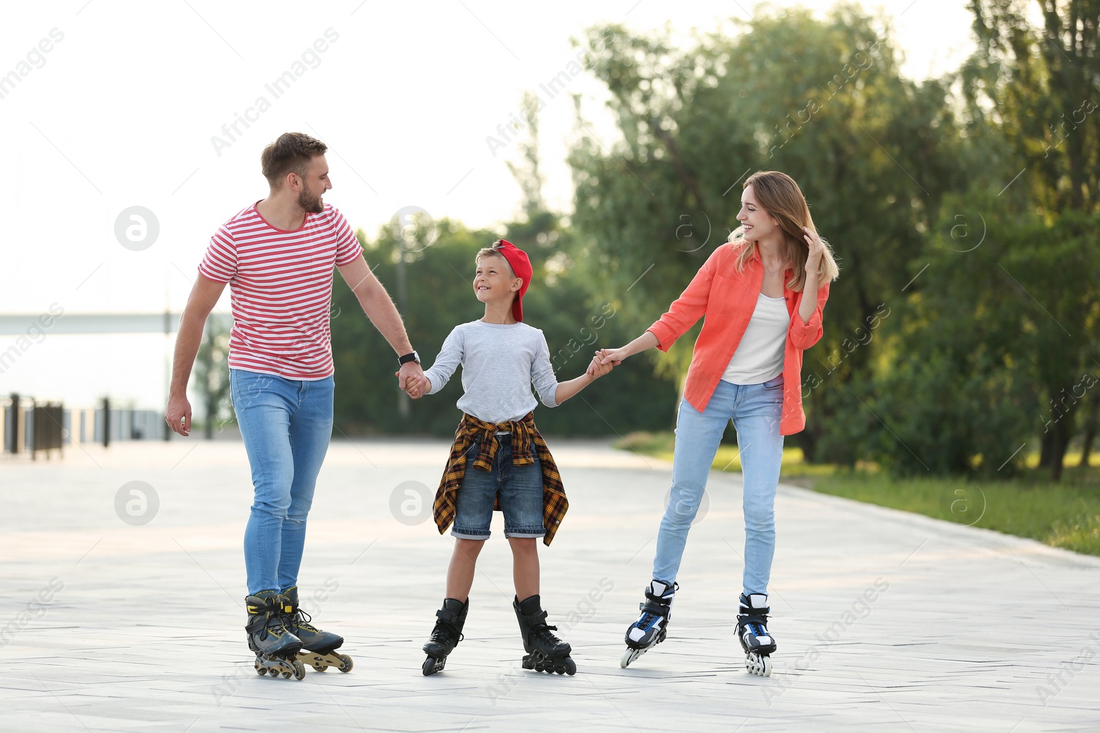 Photo of Happy family roller skating on city street