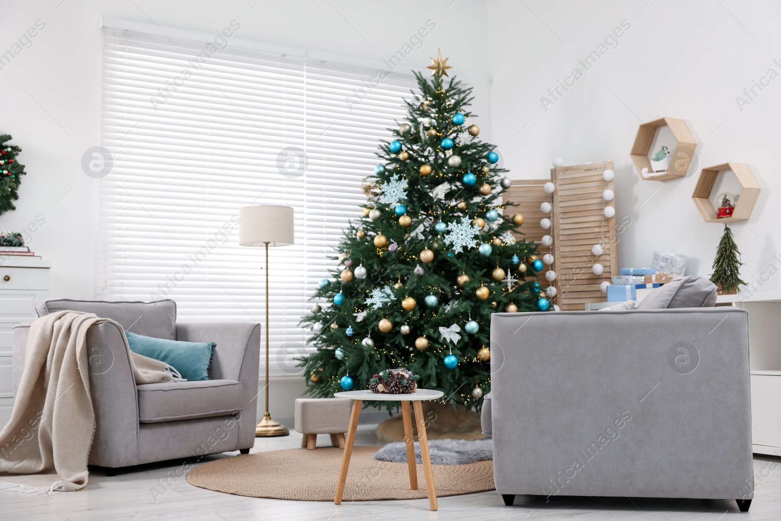 Photo of Christmas tree in room decorated for holiday. Festive interior design