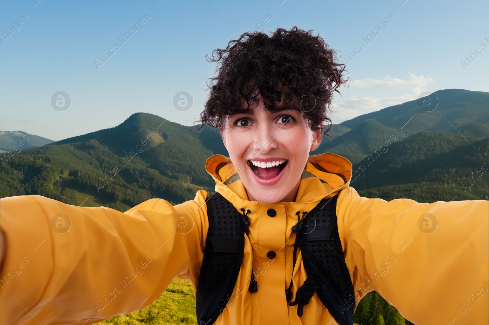 Image of Beautiful young woman taking selfie in mountains