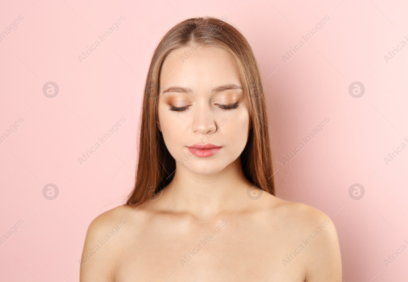 Photo of Portrait of beautiful young woman with natural makeup on color background