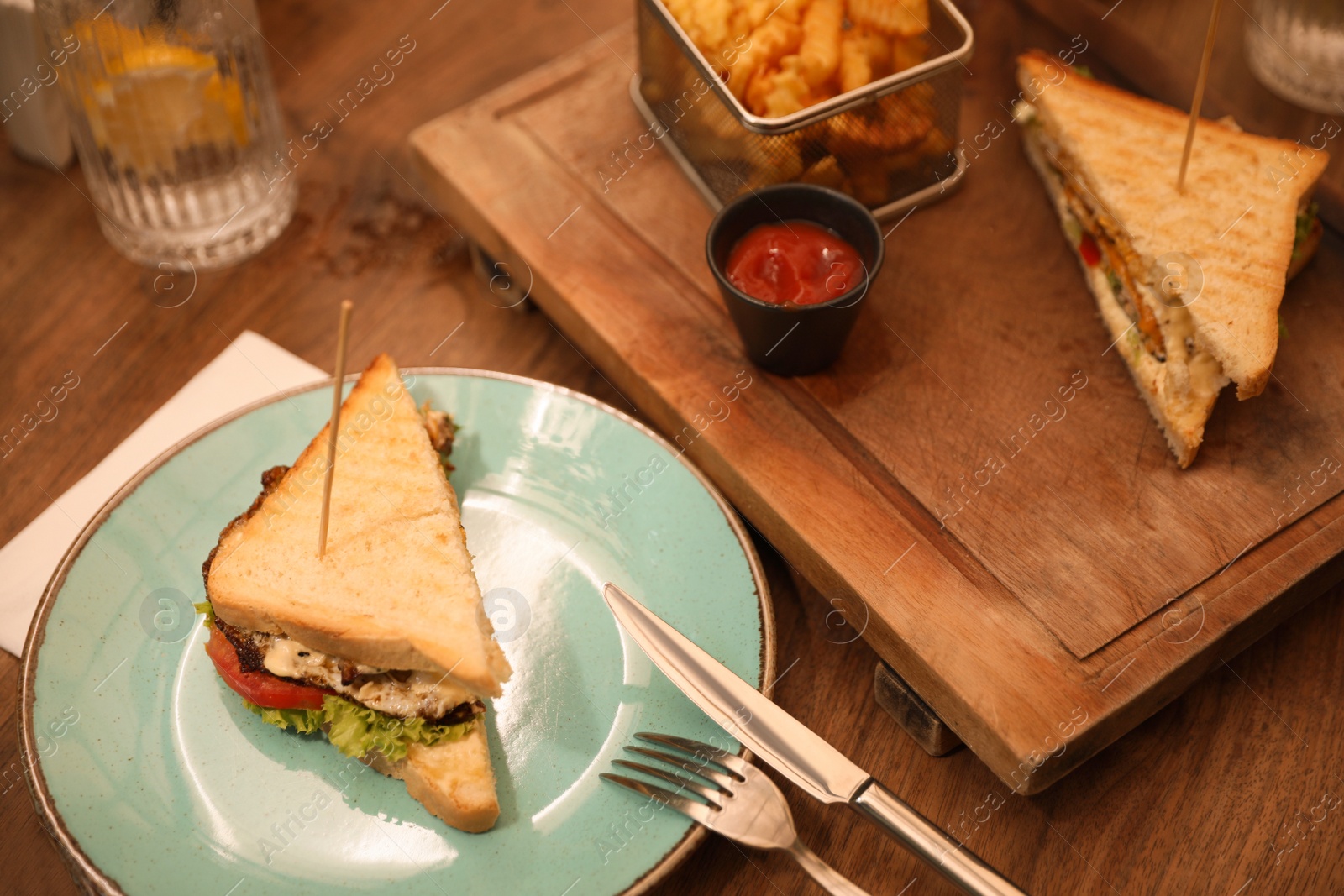 Photo of Delicious fried sandwich served on wooden table