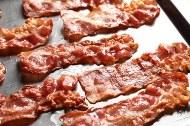 Photo of Baking sheet with bacon, closeup