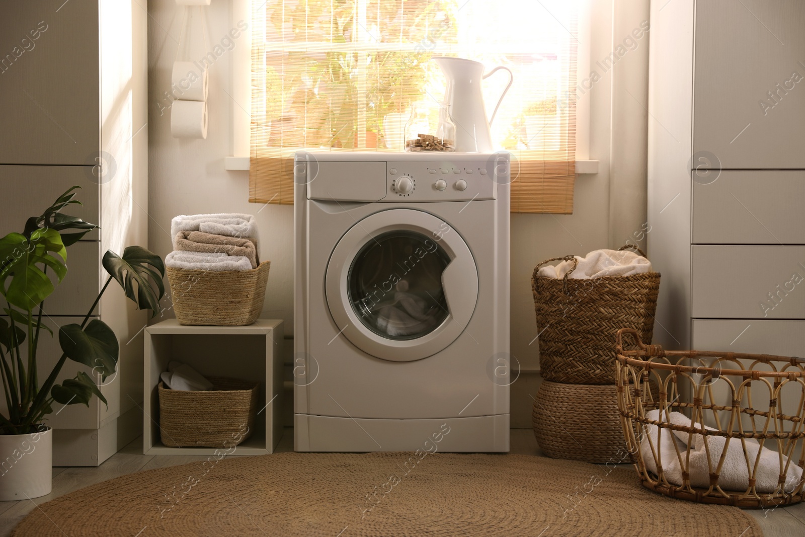 Photo of Stylish room interior with washing machine. Design idea