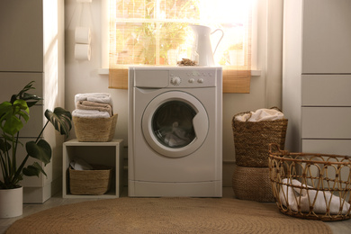 Photo of Stylish room interior with washing machine. Design idea