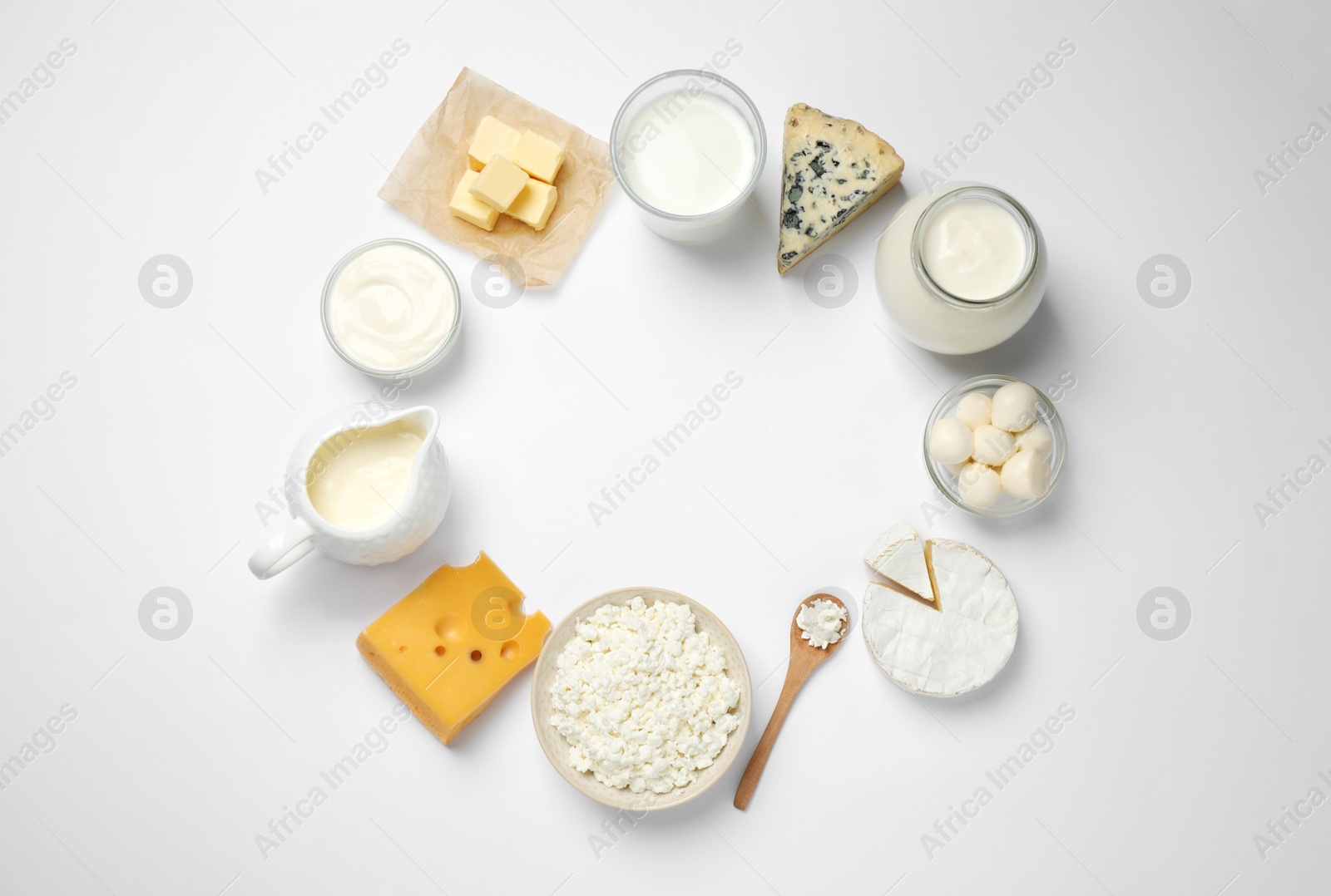 Photo of Frame made with different dairy products on white background, top view. Space for text