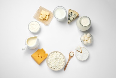 Photo of Frame made with different dairy products on white background, top view. Space for text