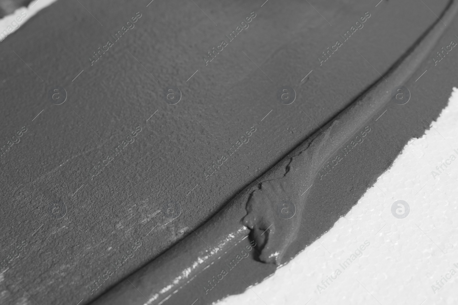 Photo of Wet concrete on white background, closeup view