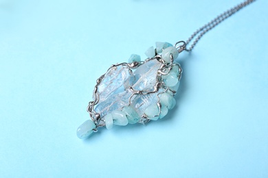 Beautiful silver necklace with pure quartz gemstones on light blue background