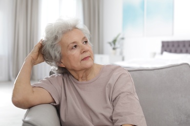 Portrait of mature woman in living room