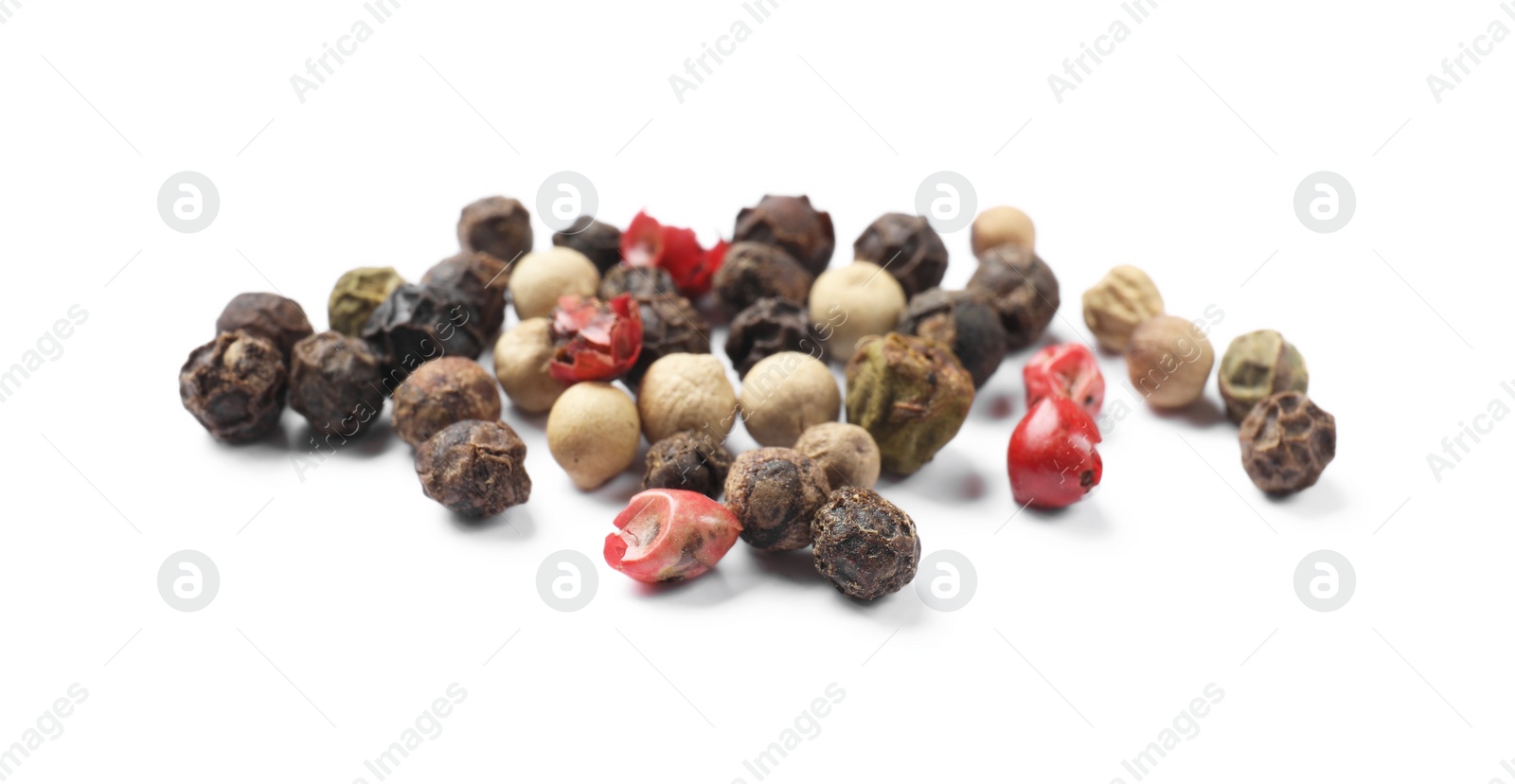 Photo of Aromatic spices. Pile of different peppers isolated on white