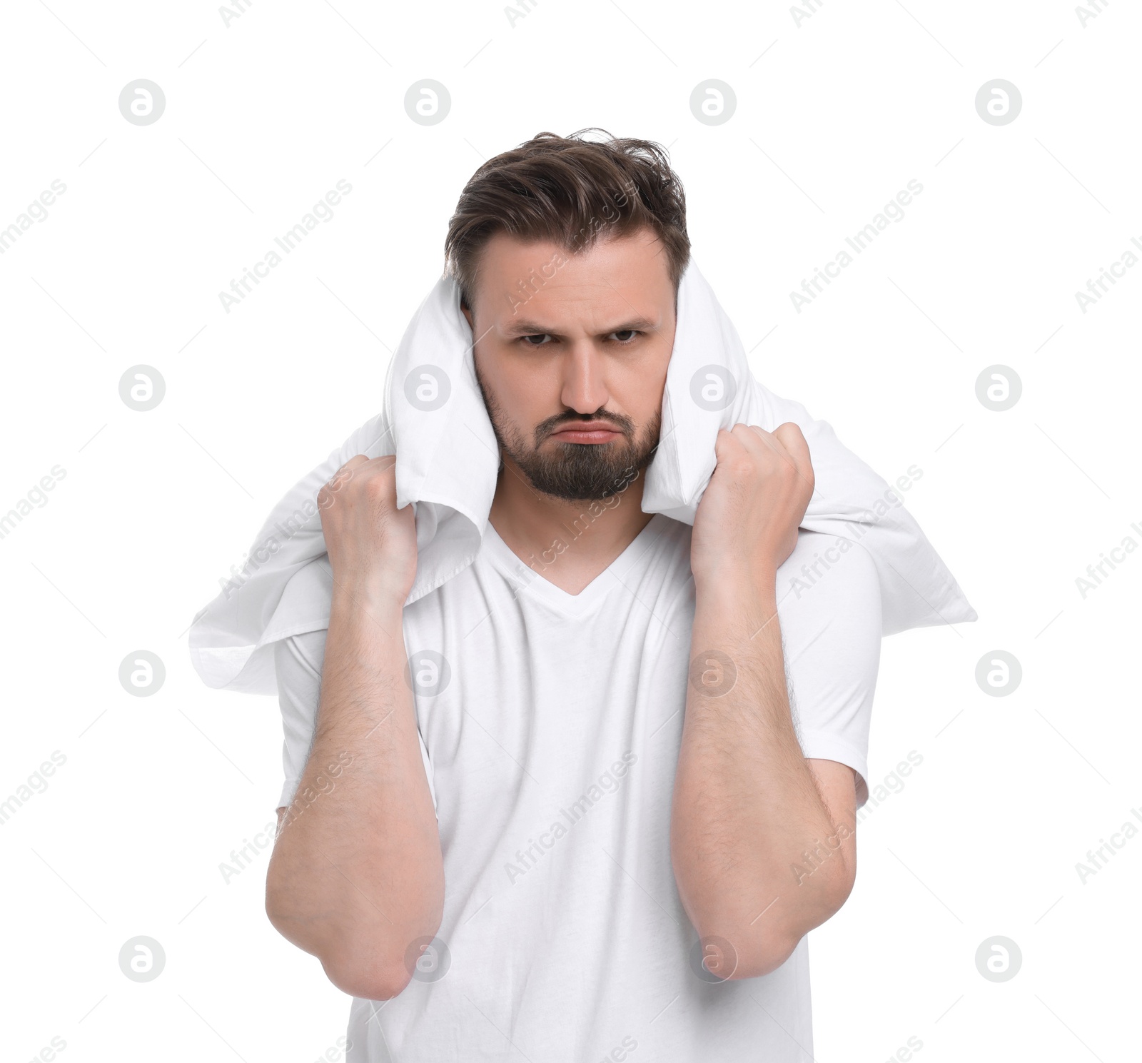 Photo of Unhappy man with pillow on white background. Insomnia problem