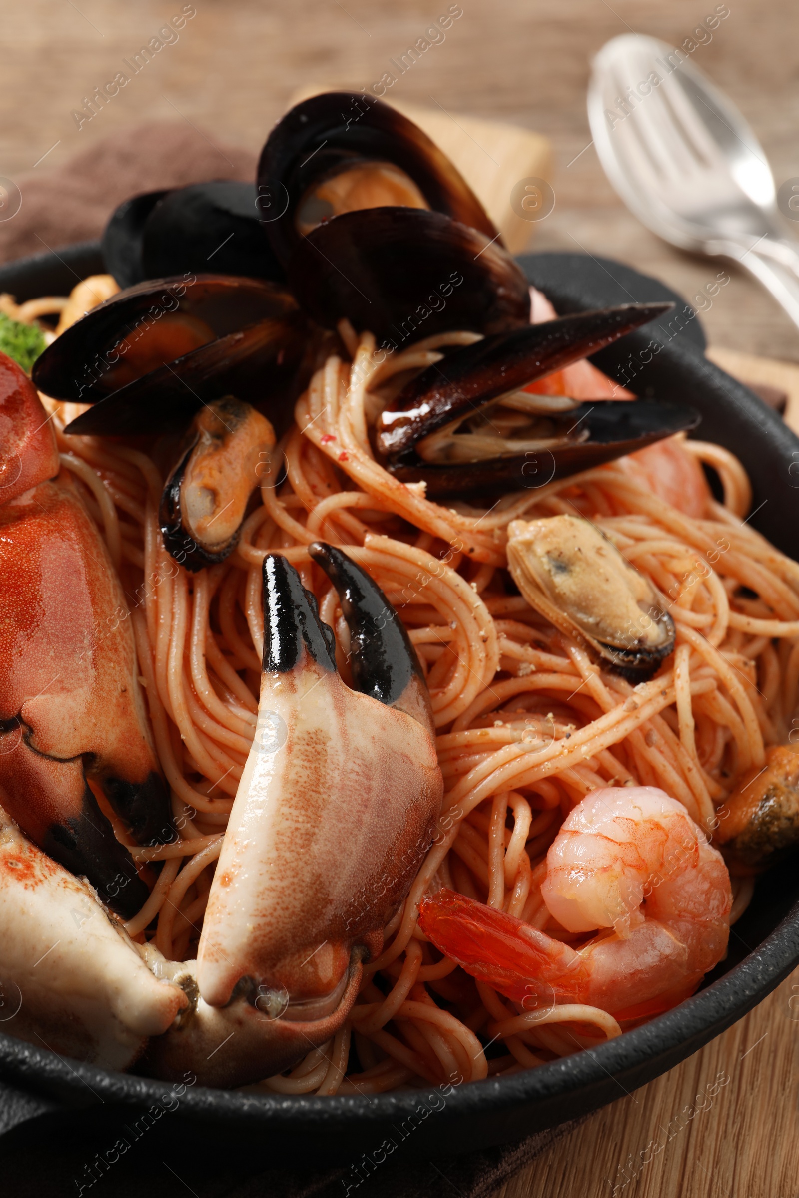 Photo of Delicious spaghetti with seafood on table, closeup