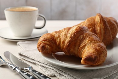 Delicious fresh croissants served on table, closeup