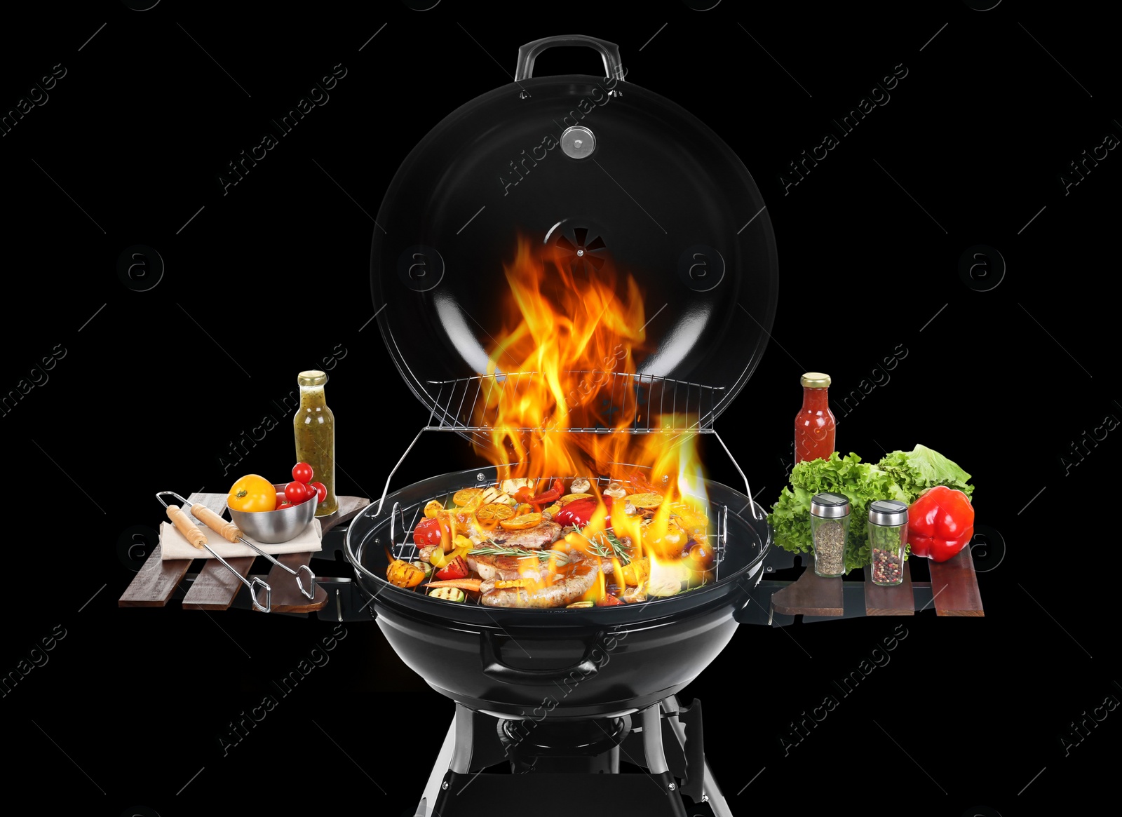 Image of Modern flaming barbecue grill with tasty food on black background