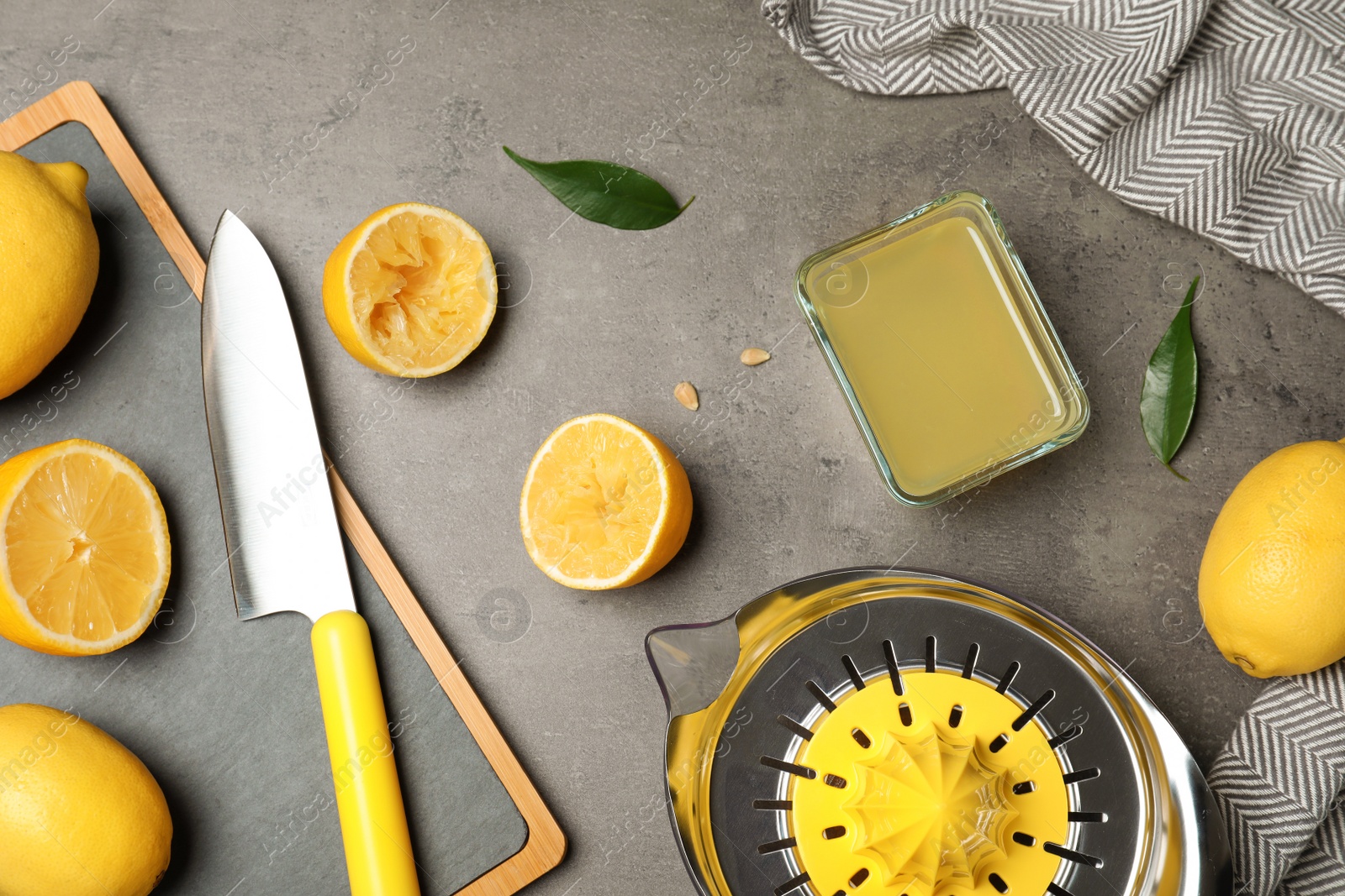 Photo of Flat lay composition with freshly squeezed lemon juice on table