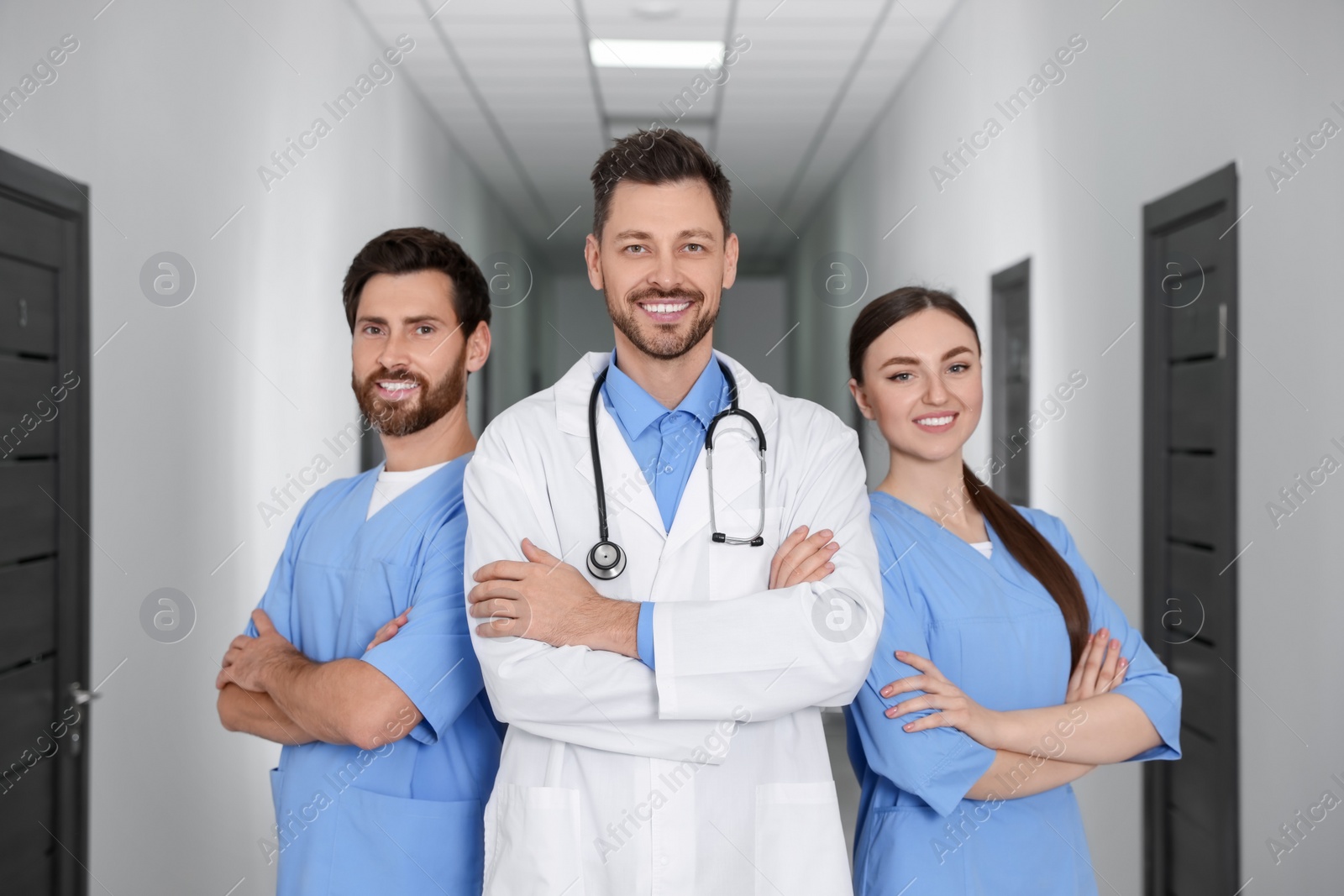 Photo of Team of professional doctors in clinic hallway